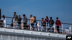 Los pasajeros son fotografiados en el crucero MSC Armony, atracado en el puerto de Barcelona, España, el miércoles 3 de abril de 2024.