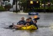 Matthew Koziol, Matías Ricci, Manuel Ricci y Raúl Fernández viajan en balsa por una calle inundada por las fuertes lluvias en North Bay Road en Sunny Isles Beach, Florida, el miércoles 12 de junio de 2024