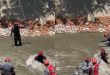 Firefighters from Caracas rescue man after falling to the Guaire River