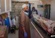 Un trabajador palestino se encuentra en una morgue cerca de un cadáver en un hospital tras un bombardeo israelí, el 7 de septiembre de 2024, en Deir el-Balah, en el centro de la Franja de Gaza. (Foto de Eyad BABA / AFP)